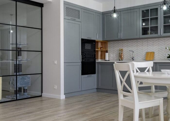 Trendy grey and white modern kitchen furniture in studio apartment